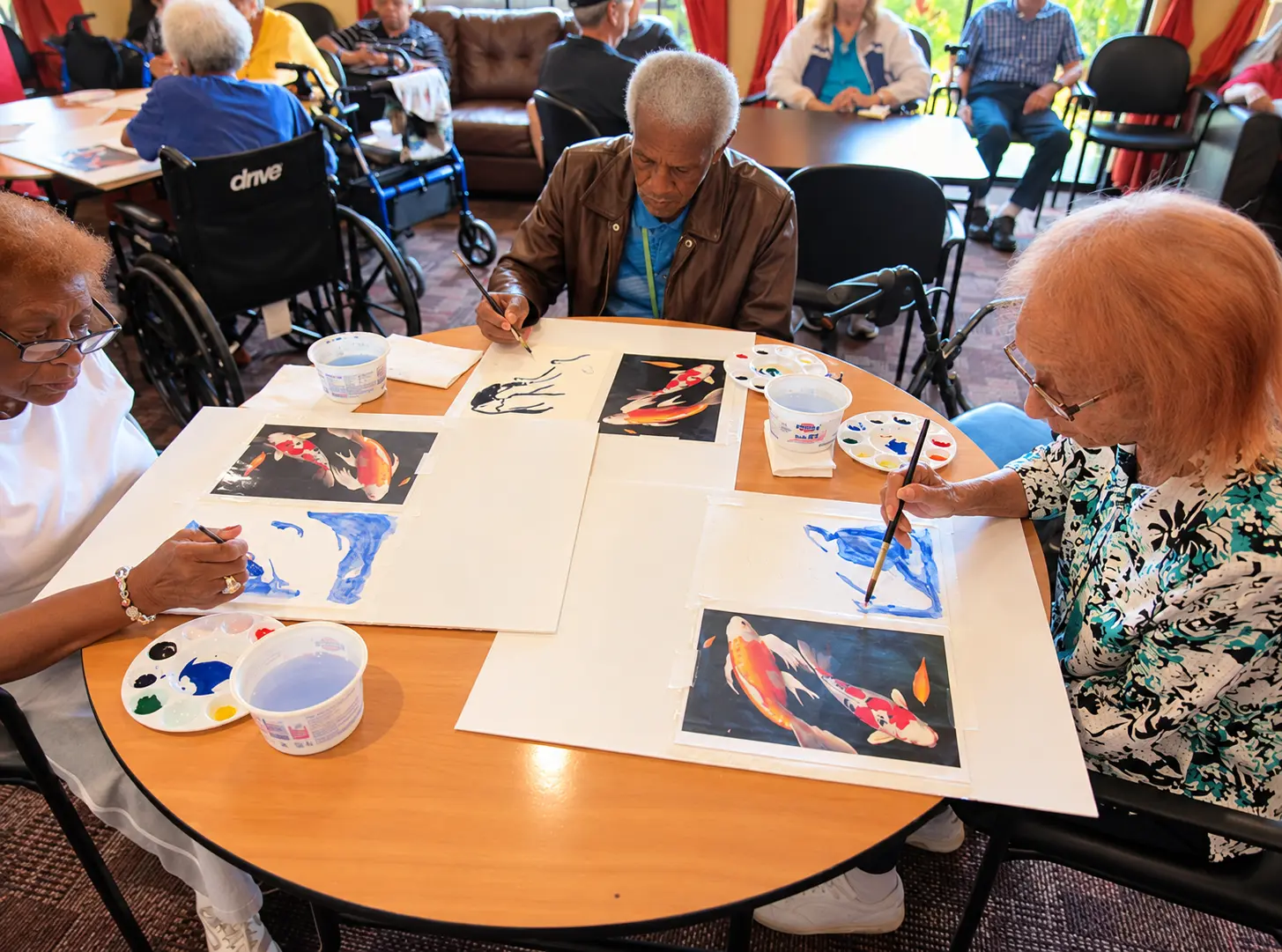 Residents painting together during an art class