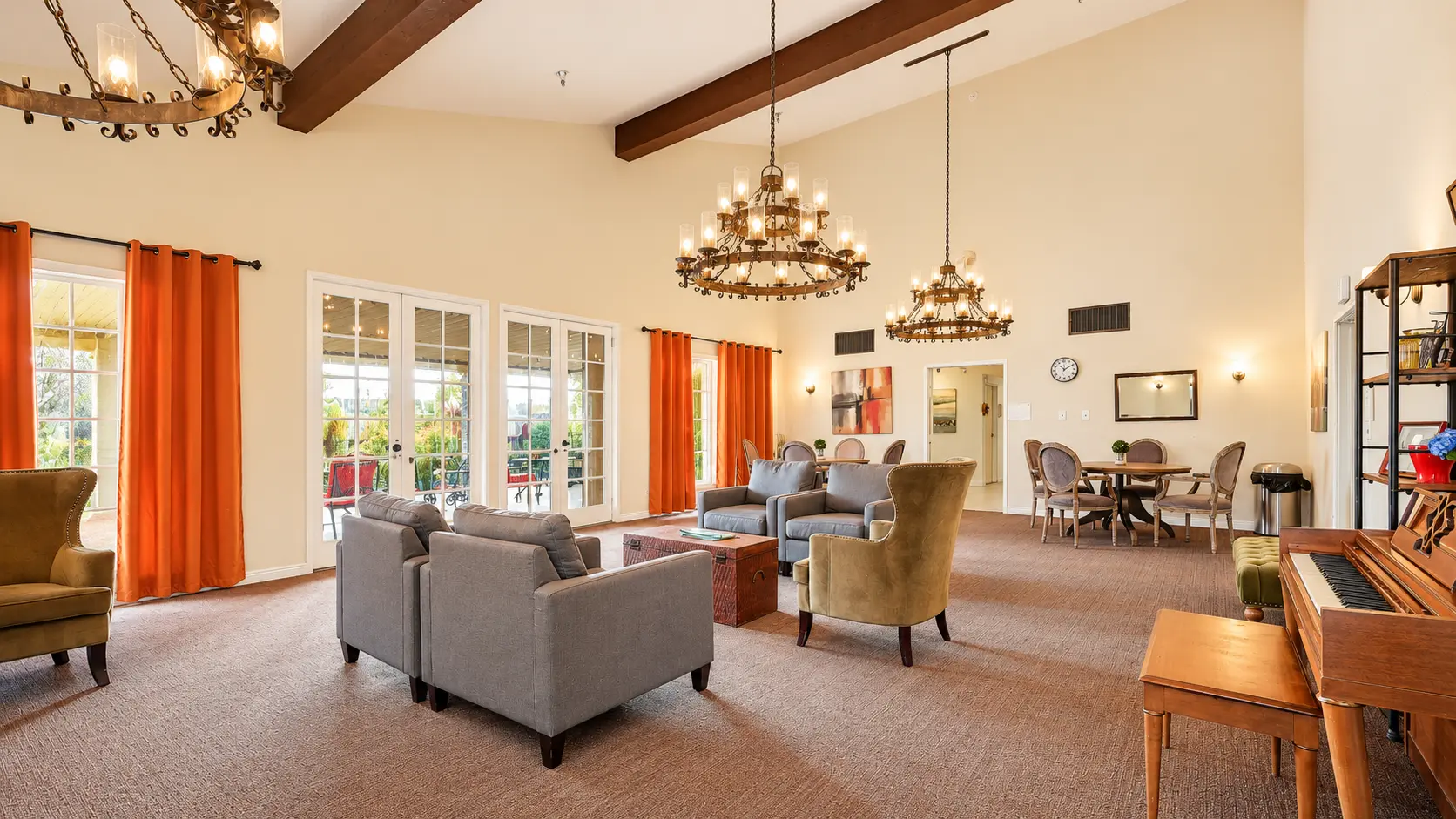 Common room with chandeliers and lounge seating