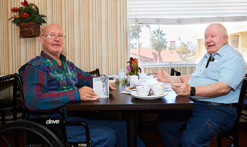 Two residents chatting over a meal